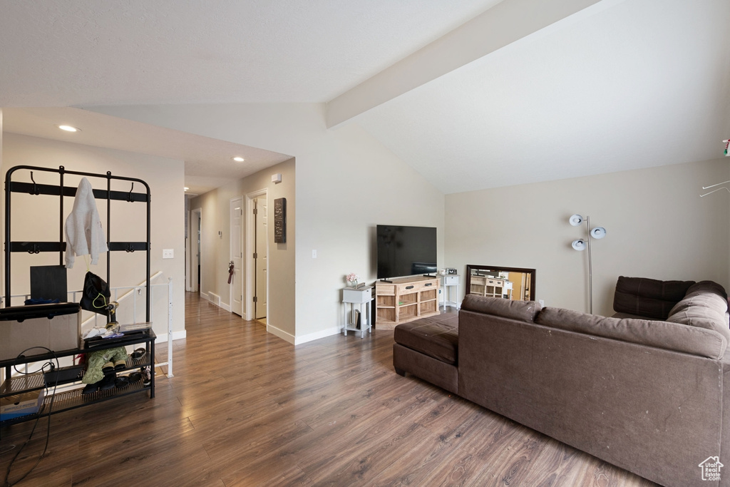 Living room with vaulted ceiling with beams and wood-type flooring