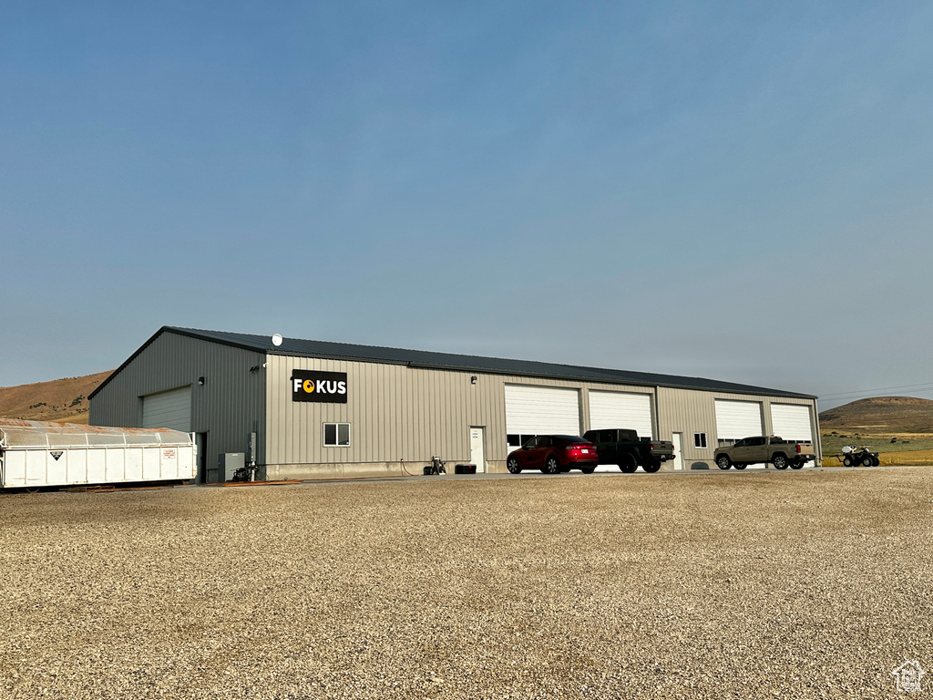 View of vehicle parking featuring a garage