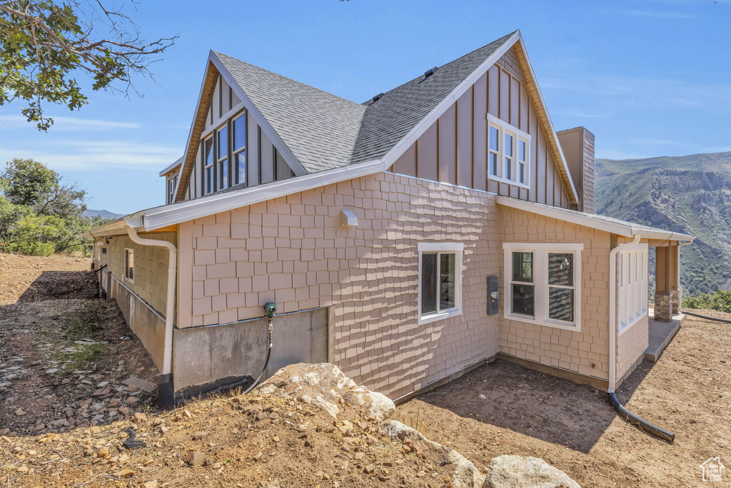 View of side of property with a mountain view