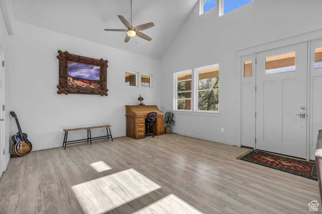 Foyer featuring ceiling fan, light hardwood / wood-style flooring, and high vaulted ceiling