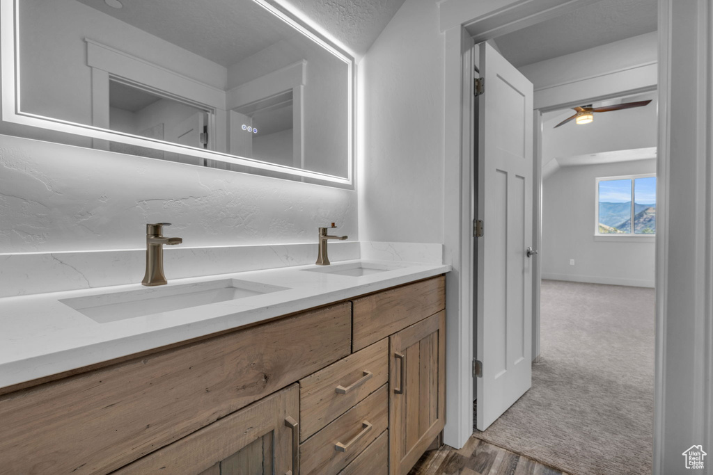 Bathroom featuring ceiling fan, hardwood / wood-style flooring, and vanity