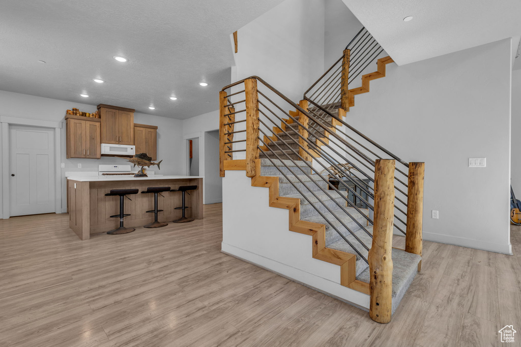 Staircase featuring wood-type flooring