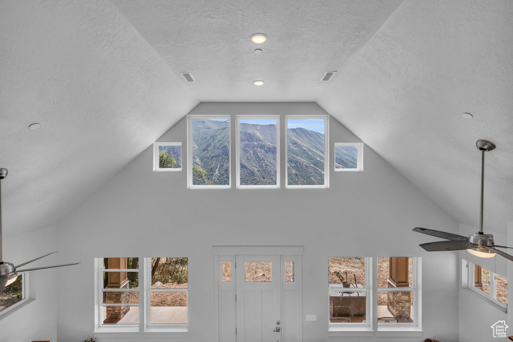 Interior space featuring a textured ceiling and ceiling fan