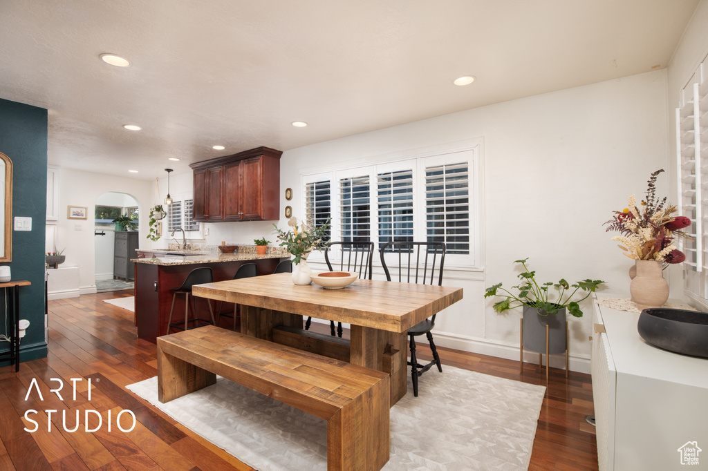 Dining room with sink and dark hardwood / wood-style flooring