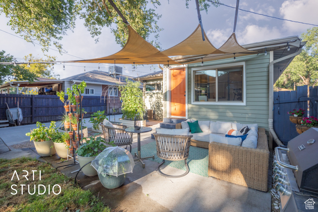 View of patio with an outdoor living space and area for grilling