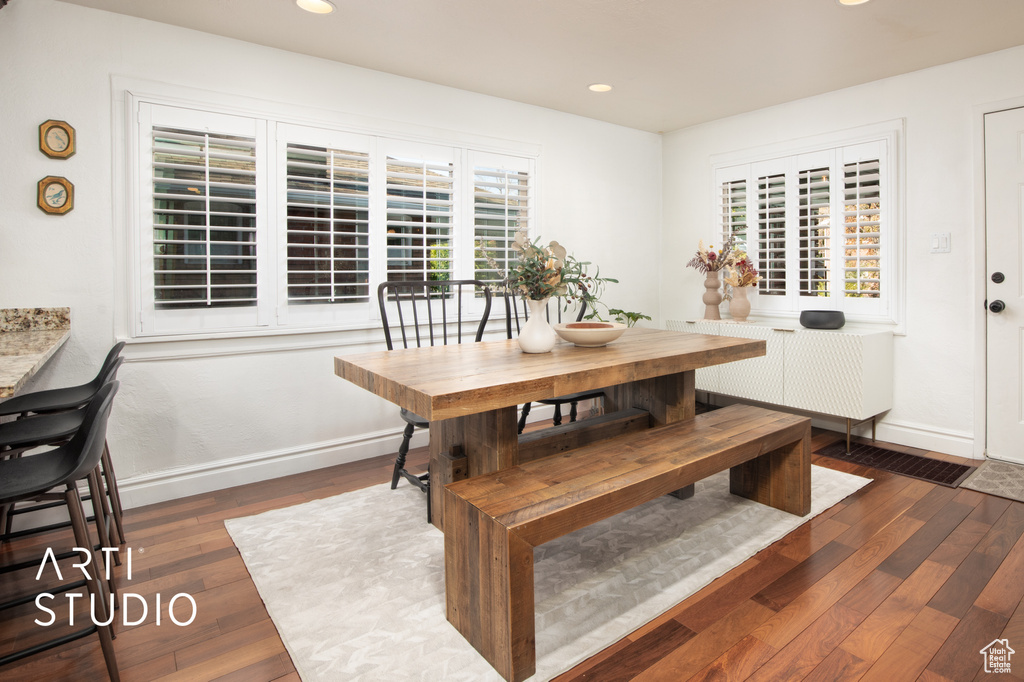 Dining room with a wealth of natural light and dark hardwood / wood-style flooring