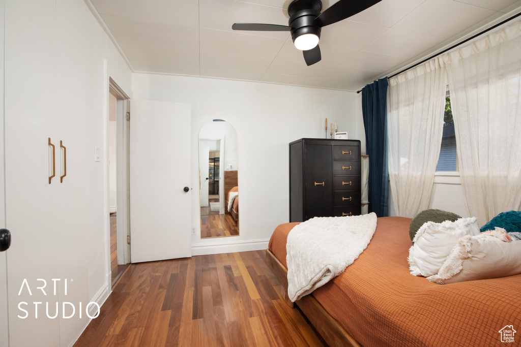 Bedroom with ceiling fan and hardwood / wood-style floors