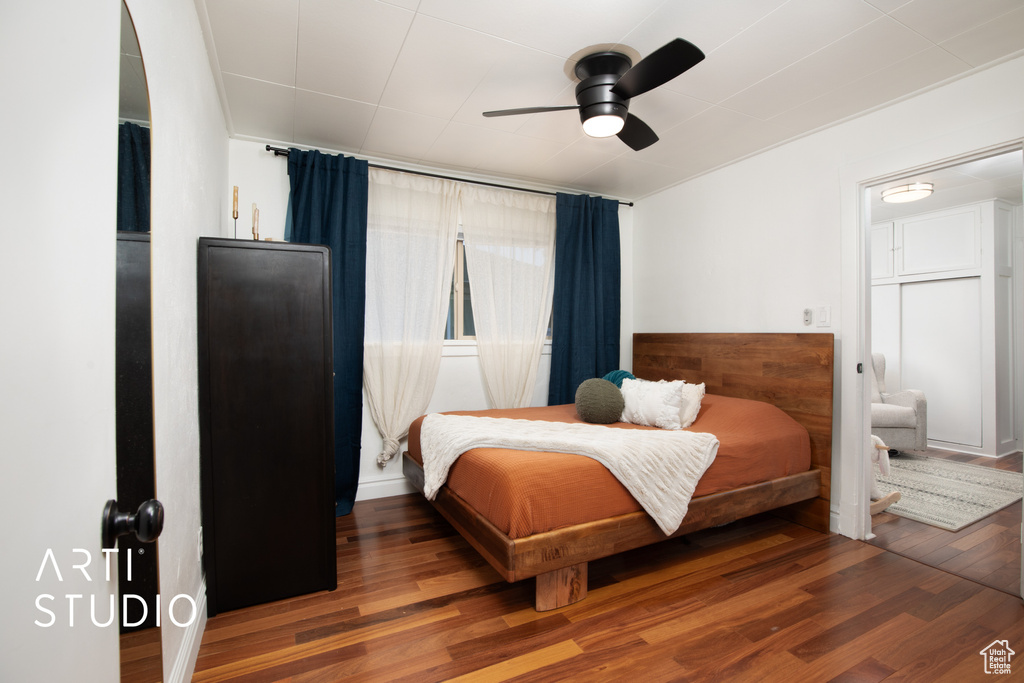 Bedroom featuring ceiling fan and dark hardwood / wood-style flooring