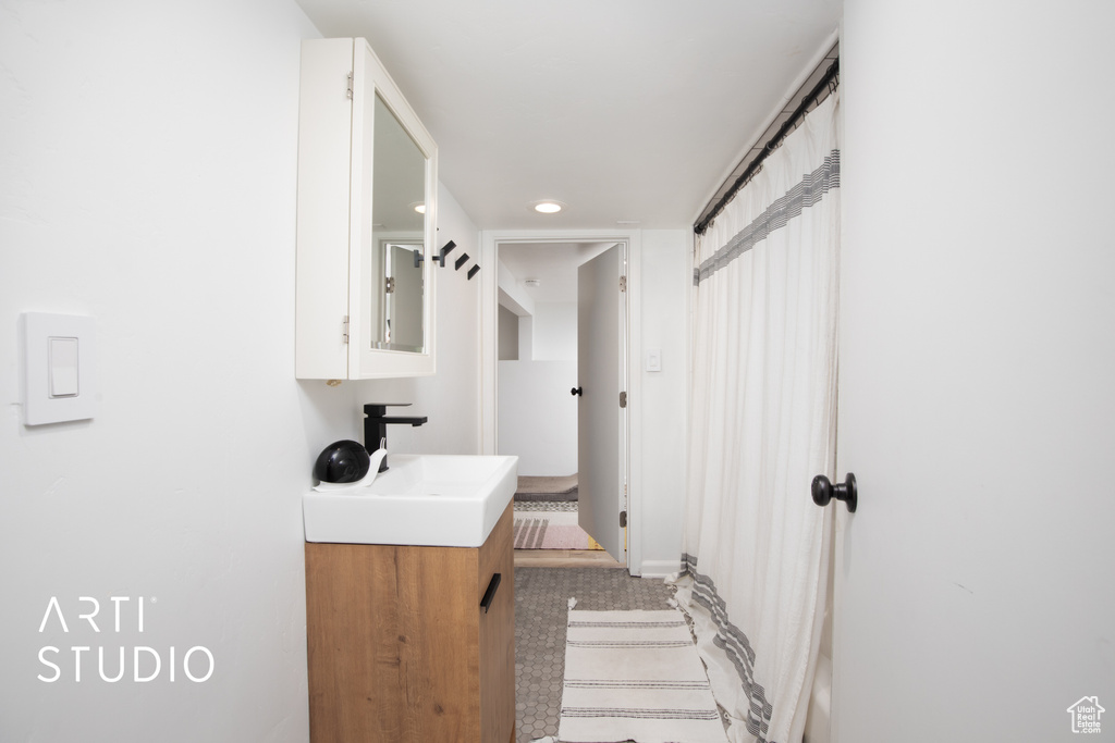 Bathroom with tile patterned floors and vanity