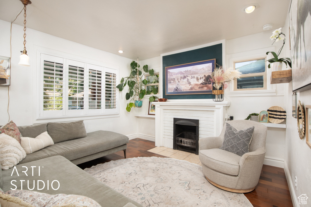 Living room with hardwood / wood-style floors and a brick fireplace