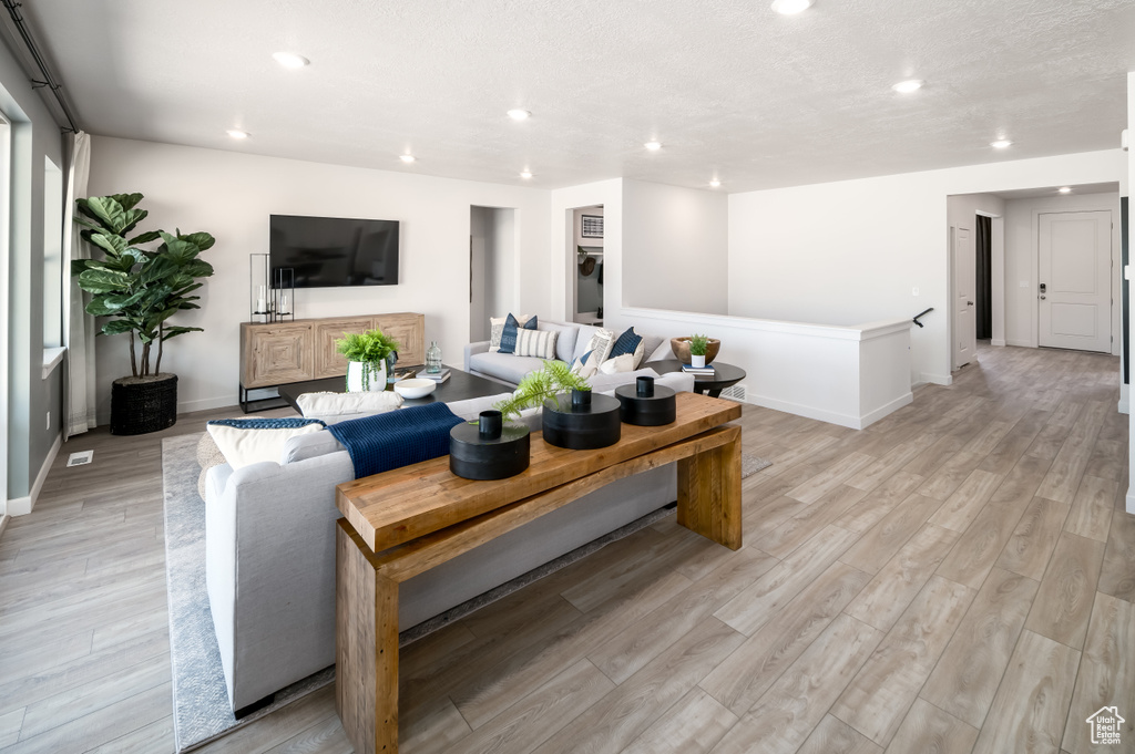 Living room with light hardwood / wood-style flooring