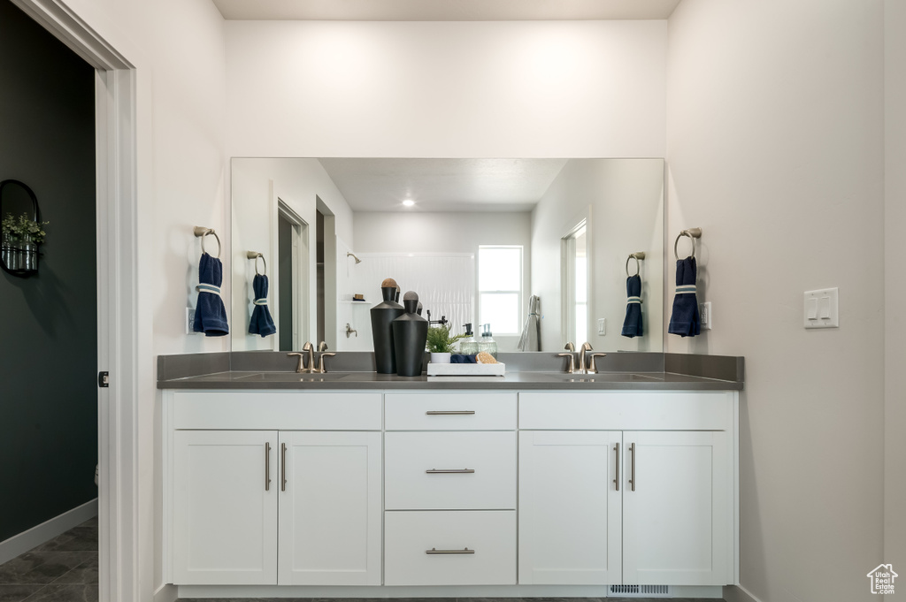 Bathroom featuring tile patterned flooring and vanity