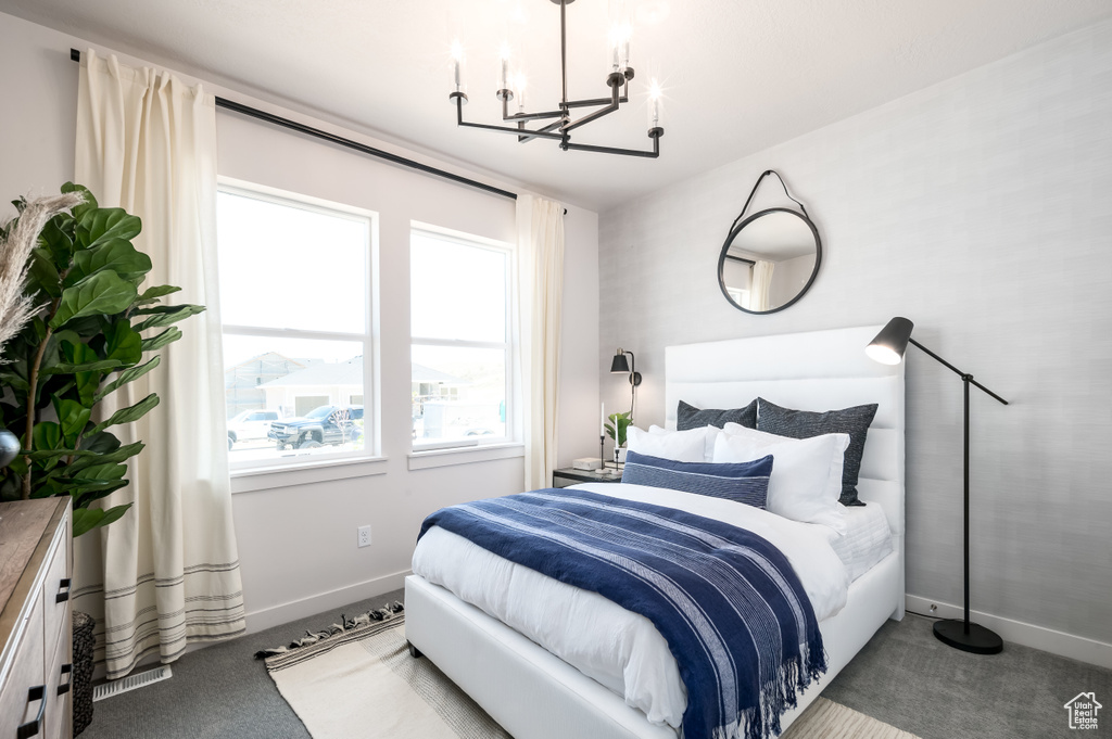 Bedroom with carpet floors and a chandelier