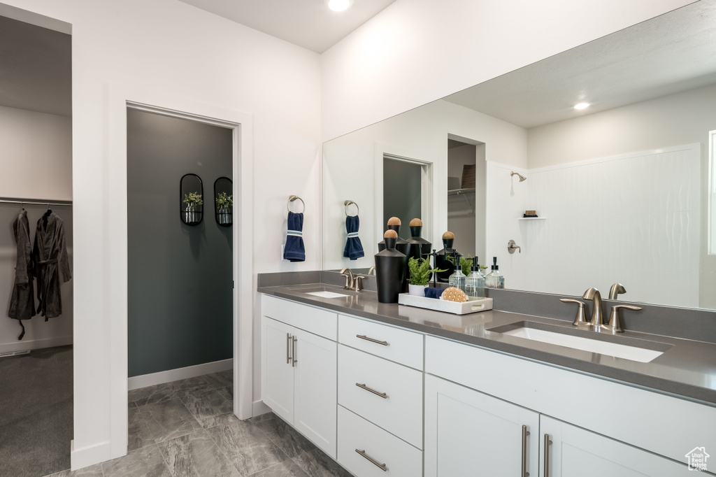 Bathroom featuring tile patterned flooring and vanity