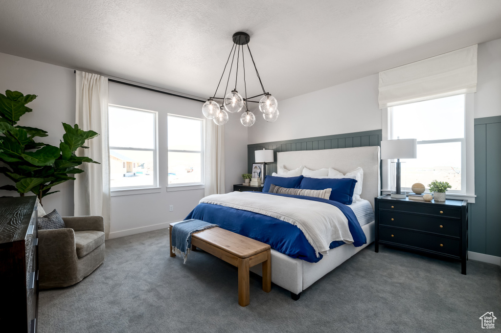 Bedroom with carpet floors and a chandelier