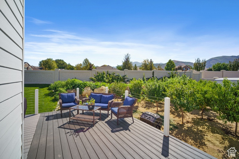 Wooden terrace with an outdoor living space and a mountain view