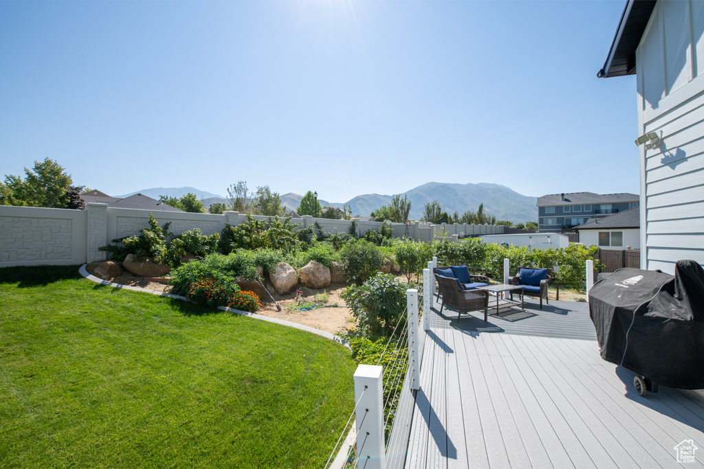 View of yard with a deck with mountain view and an outdoor living space