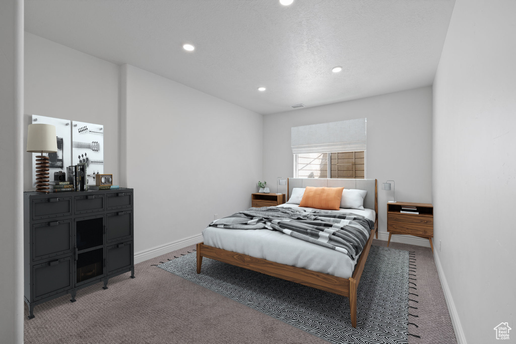 Bedroom featuring a textured ceiling and carpet flooring