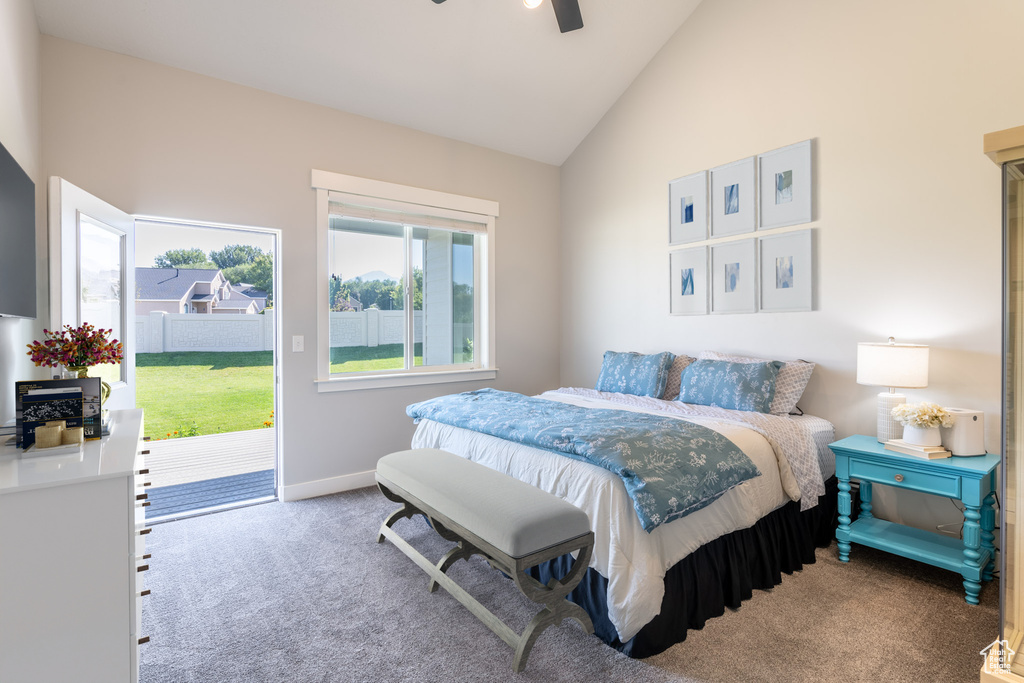 Bedroom featuring ceiling fan, light colored carpet, access to outside, and vaulted ceiling