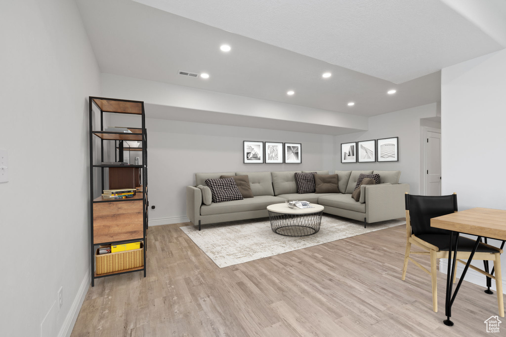 Living room with light hardwood / wood-style floors