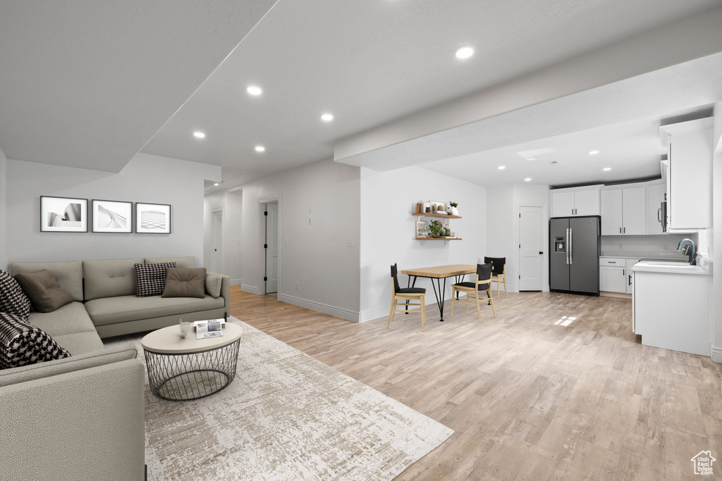 Living room with sink and light hardwood / wood-style floors