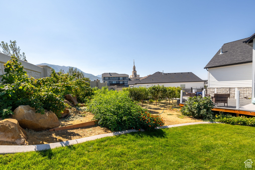 View of yard with a deck with mountain view