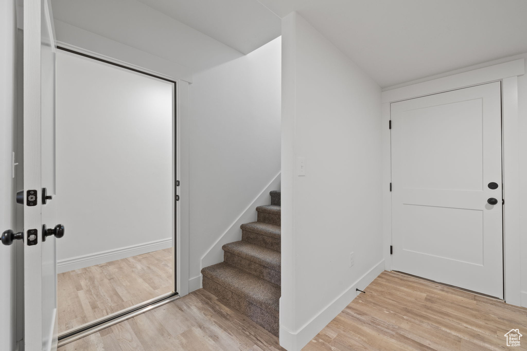 Foyer with light hardwood / wood-style flooring