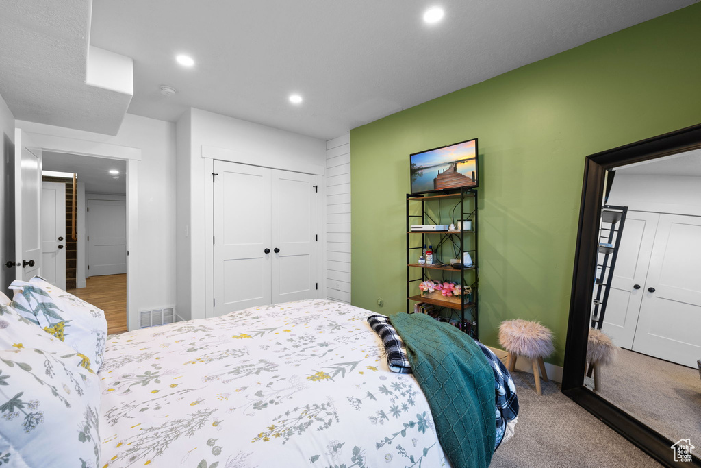 Carpeted bedroom featuring a closet