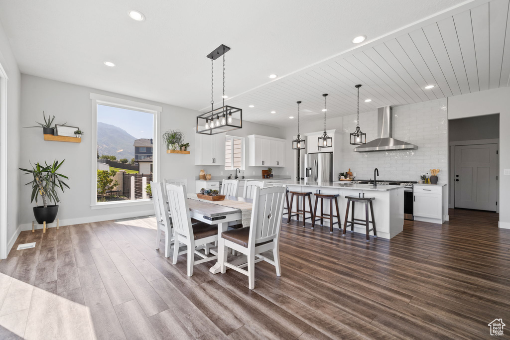 Dining area with dark wood-type flooring and sink