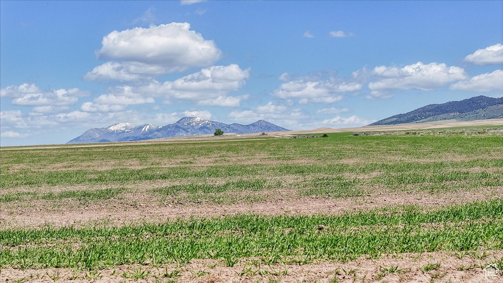 View of mountain backdrop with rural landscape