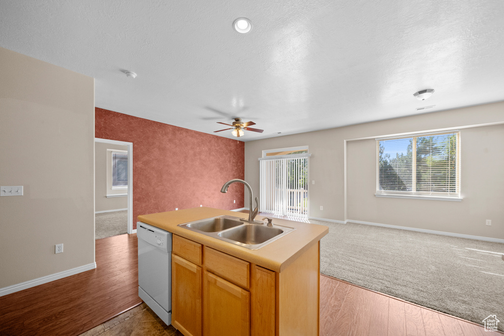 Kitchen featuring light hardwood / wood-style floors, sink, a kitchen island with sink, white dishwasher, and ceiling fan