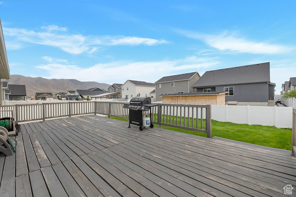 Deck with a yard and area for grilling