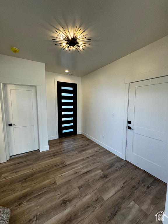 Empty room with dark hardwood / wood-style flooring