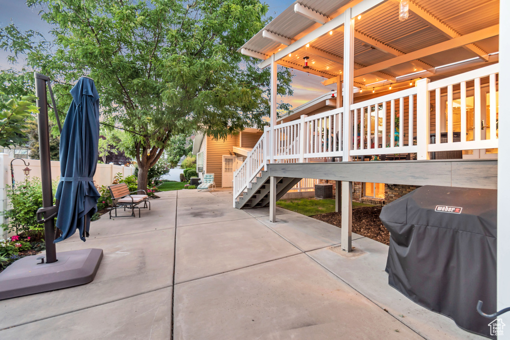 View of patio with a grill