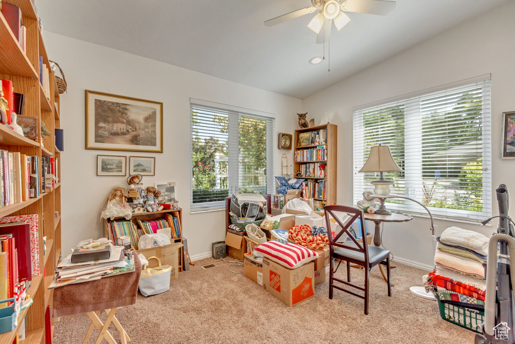 Playroom with ceiling fan, light colored carpet, and lofted ceiling