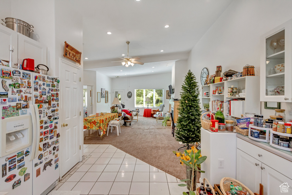 Game room with ceiling fan, vaulted ceiling, and light colored carpet