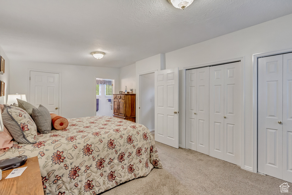 Carpeted bedroom featuring two closets