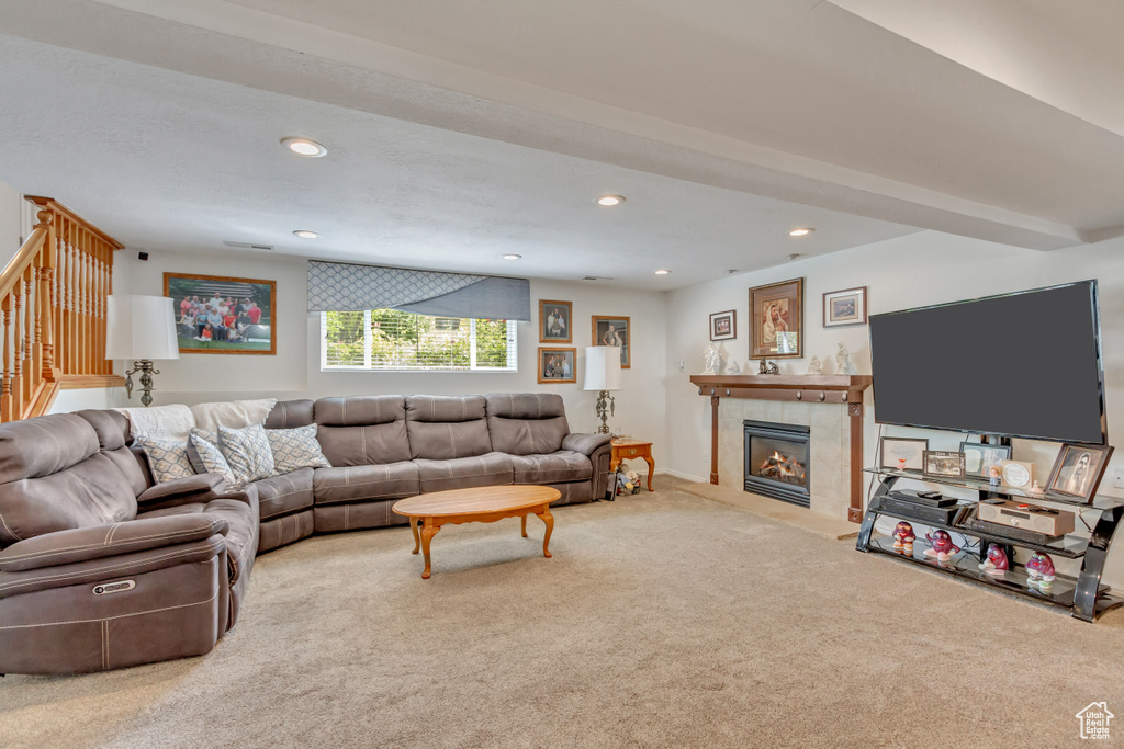 Carpeted living room with a tile fireplace