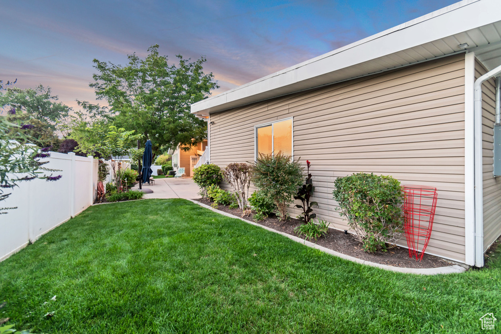 Property exterior at dusk with a yard