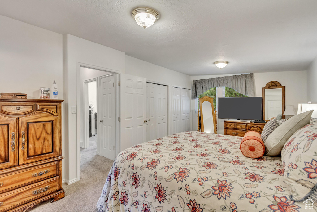 Carpeted bedroom featuring two closets