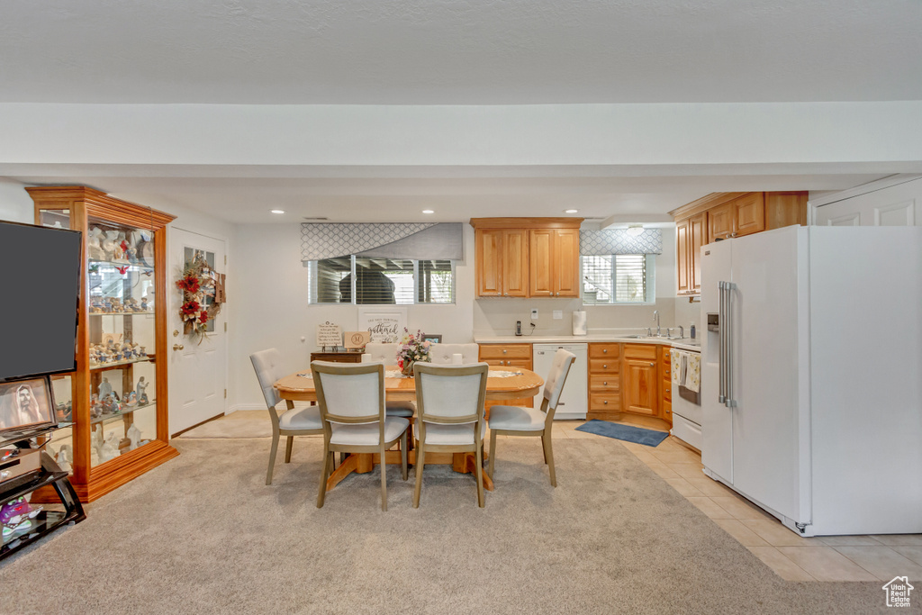 Carpeted dining space featuring sink