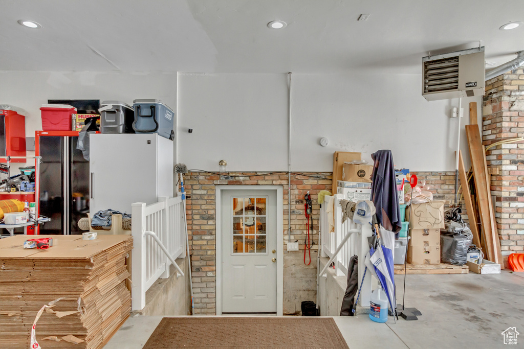 Interior space featuring concrete flooring and brick wall