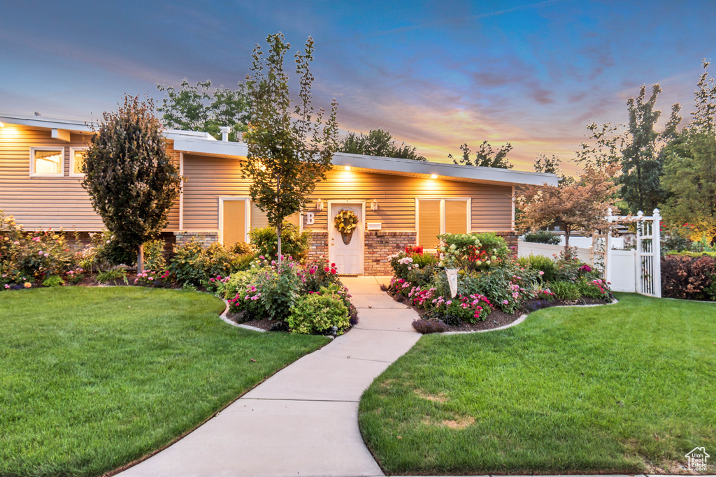 View of front of property with a lawn