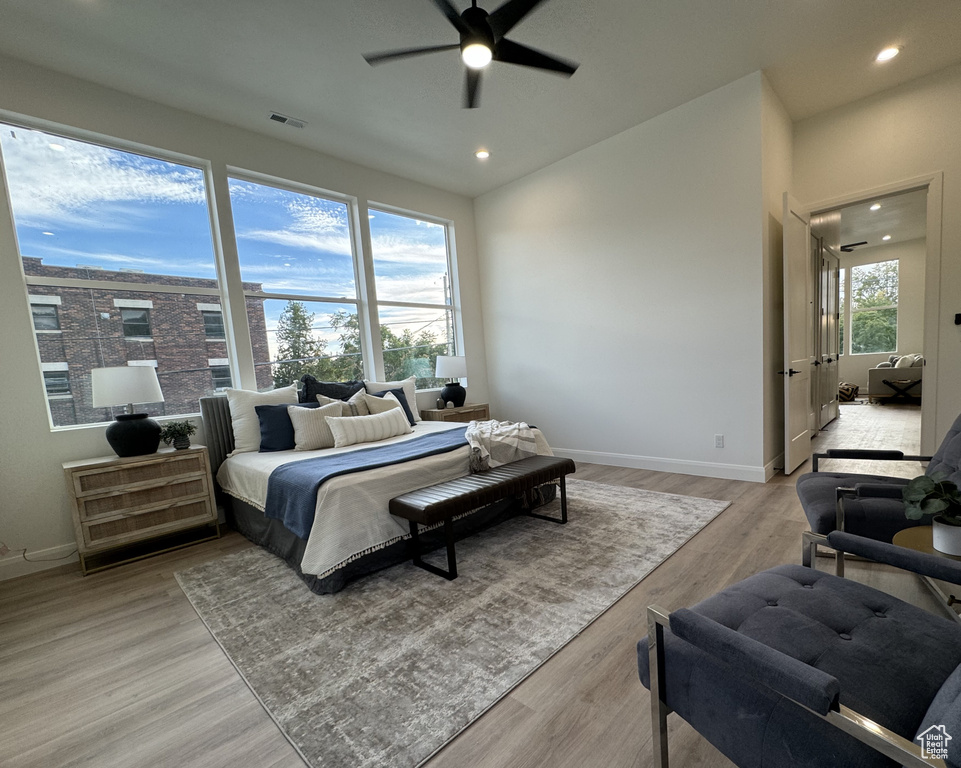 Bedroom with ceiling fan and light hardwood / wood-style flooring