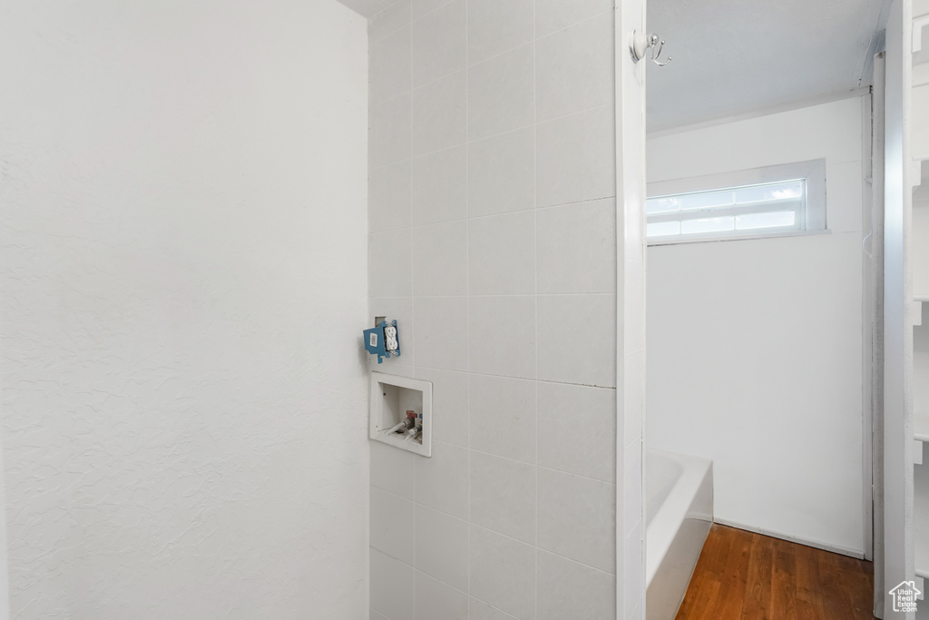 Bathroom with plus walk in shower and hardwood / wood-style floors