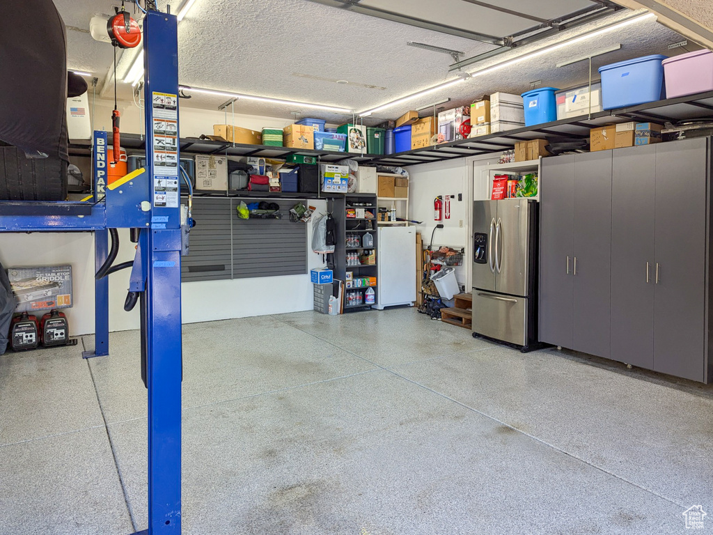 Garage featuring stainless steel fridge with ice dispenser