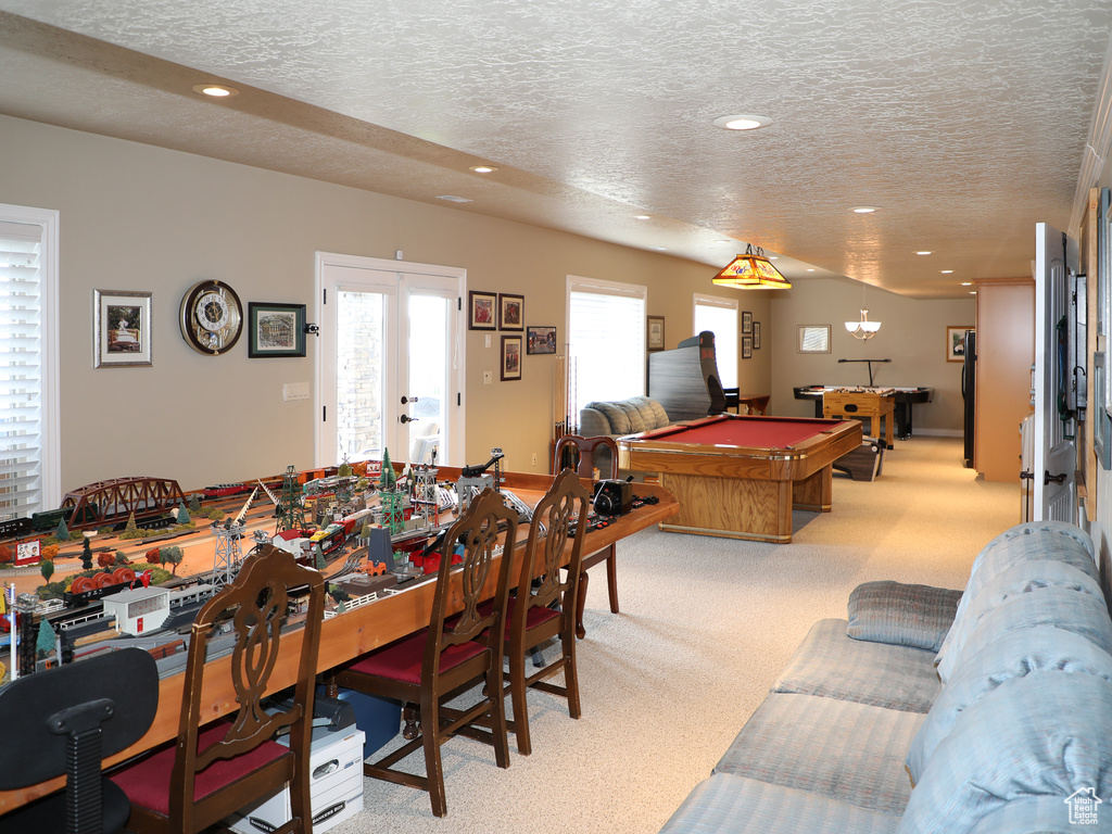 Game room with a textured ceiling, carpet, pool table, and french doors