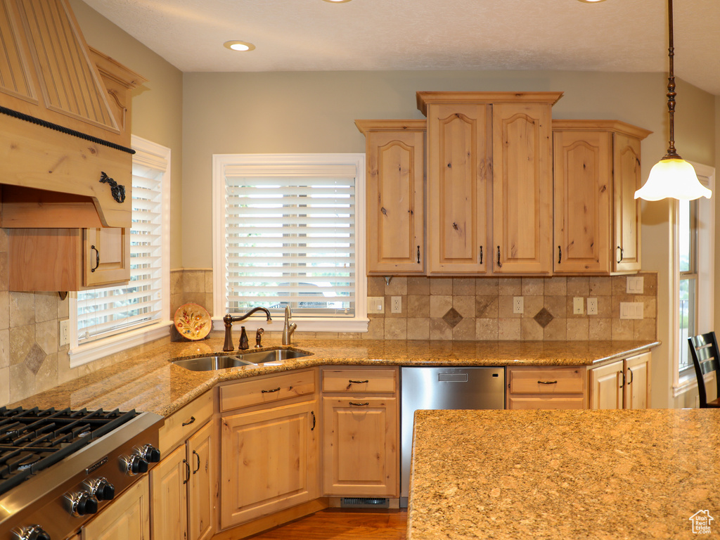 Kitchen with sink, tasteful backsplash, and a healthy amount of sunlight