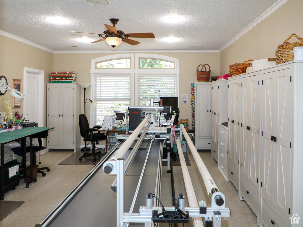 Game room featuring light carpet, a textured ceiling, ornamental molding, and ceiling fan