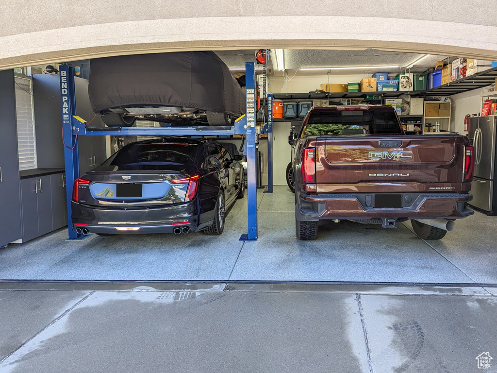 Garage with stainless steel refrigerator